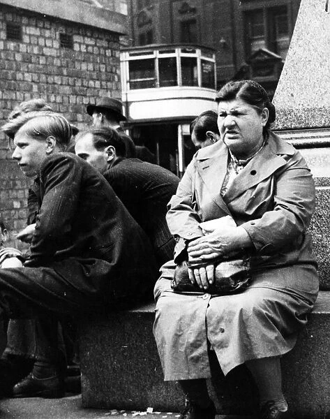 A woman hears the news of the general election in Albert Square, Manchester