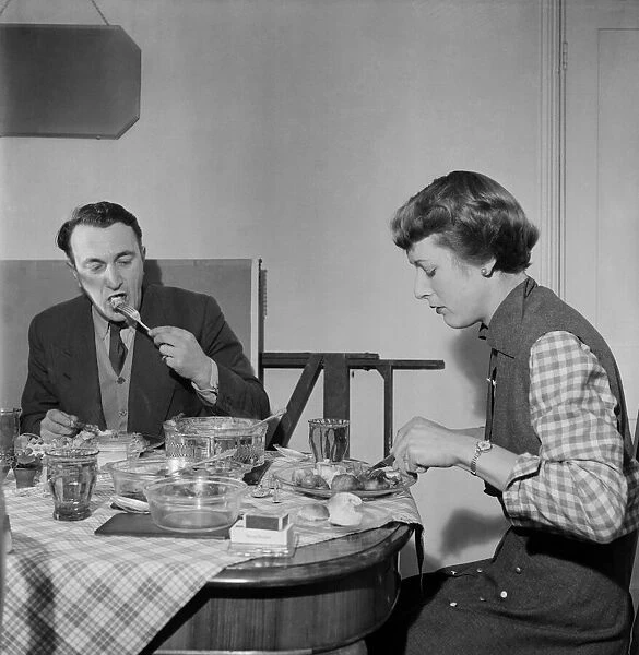 Woman at home eating dinner with her husband at the table