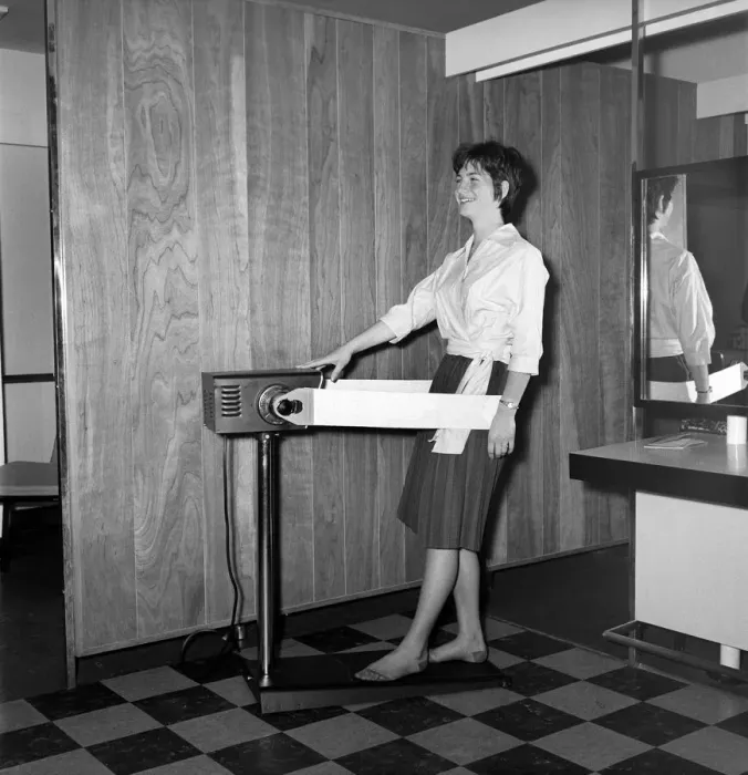 Framed Print : Woman at the John London Hair and Beauty Saloon seen here using a band vibrating slimming