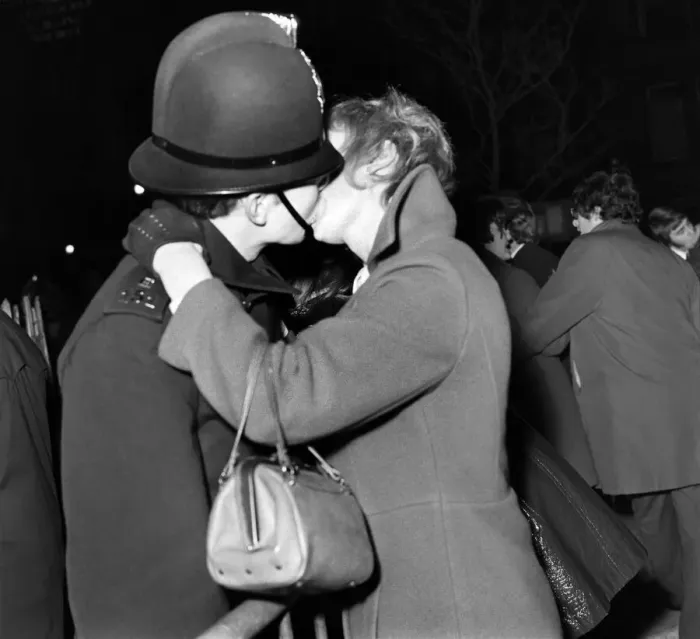 Framed Print : A woman kisses a policeman to celebrate New Year in Manchester