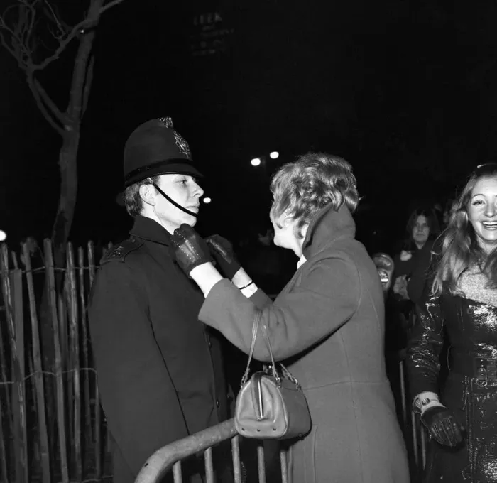 Framed Print : A woman kisses a policeman to celebrate New Year in Manchester