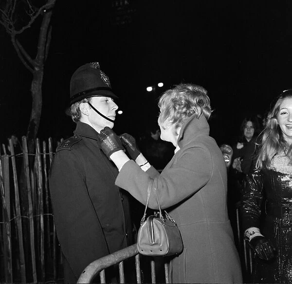 A woman kisses a policemen to celebrate New Year in Albert Square, Manchester, England