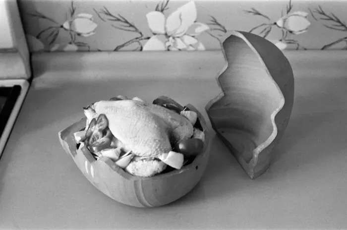 Framed Print : A woman in a kitchen cooking a chicken with a Bobo Pot. 29th March 1967