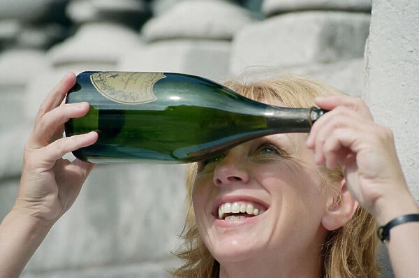 A woman in Liverpool city centre watching the solar eclipse through a bottle