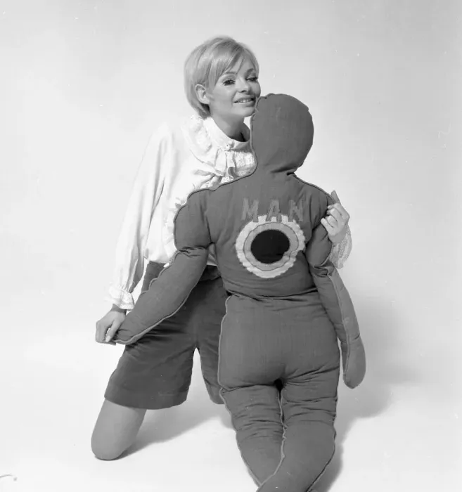 Framed Print : Woman Model with pillows in the shape of man and child. January 1968. Y5 Framed Print : Woman Model with pillows in the shape of man and child. January 1968. Y5