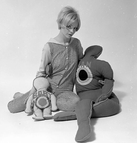 Woman Model with pillows in the shape of man and child. January 1968