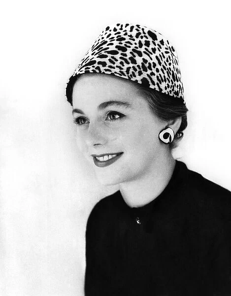 A woman modelling an animal print hat. 13th September 1955