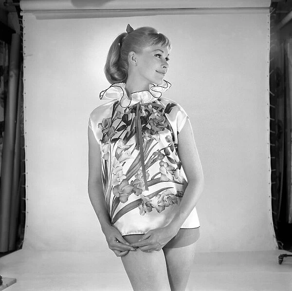 Woman modelling floral blouse. Circa 1960