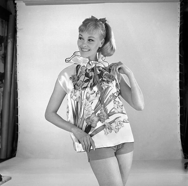 Woman modelling floral blouse. Circa 1960