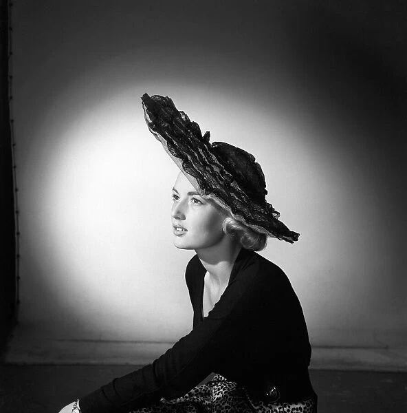 Woman modelling the latest 1956 hat fashions in the Reveille studios. June 1956