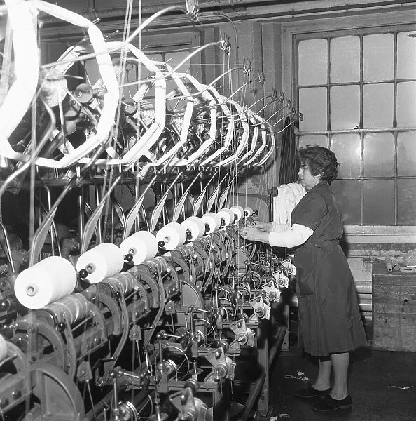 Woman operating a hank to cone machine at the factory of J Henry Smith, Cooper Street