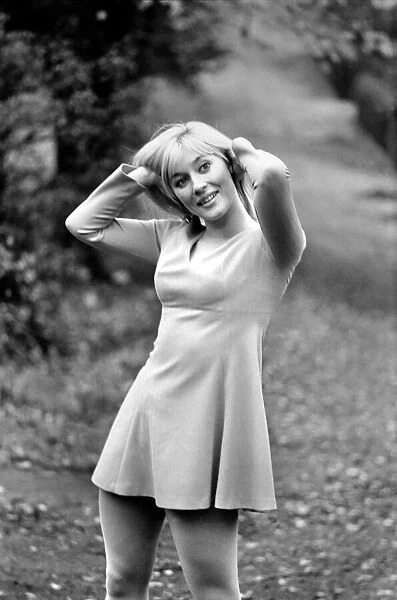 Woman outdoors posing wearing a mini dress. November 1969 Z10756-006