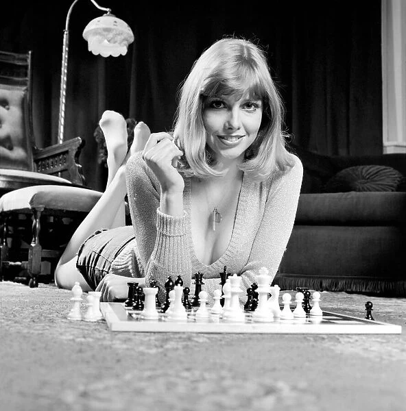 Woman pictured at home playing a game of chess. May 1975
