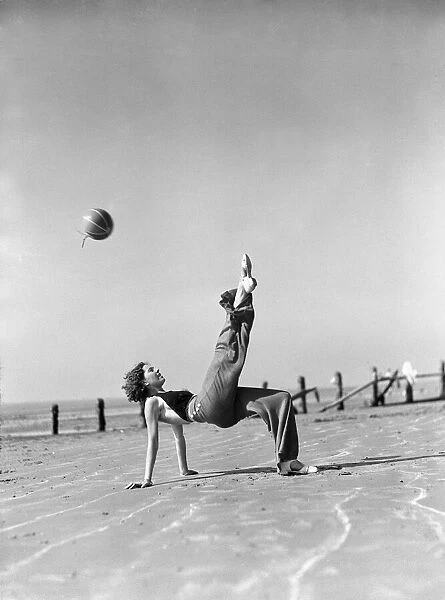 Woman playing on the beach at Elmer Sands, West Sussex. August 1933 1102