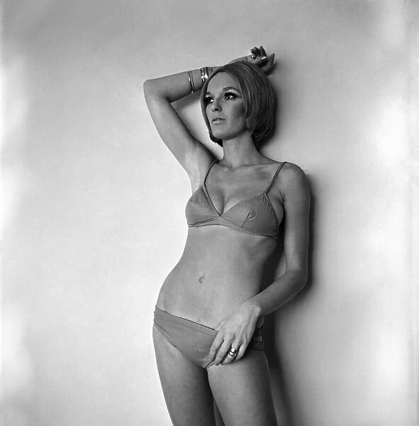 Woman poses for pictures modeling a bikini. November 1969 Z10947-004