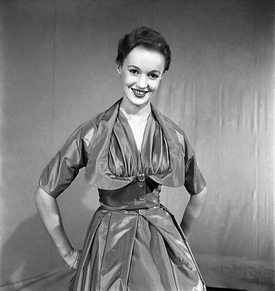 Woman poses wearing a long evening dress. November 1952 C6275