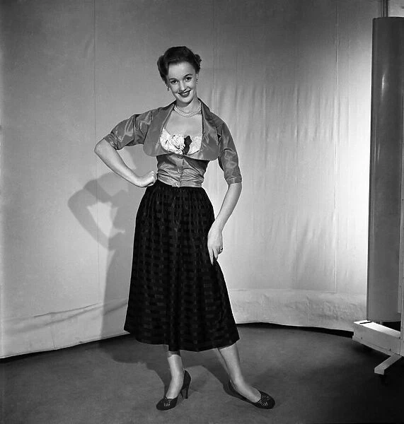 Woman poses wearing a top and long skirt November 1952 C6275-002