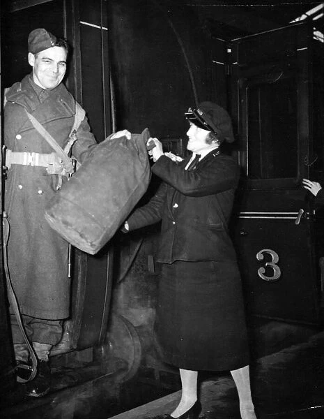 A woman railway porter at work during World War II. Circa 1941
