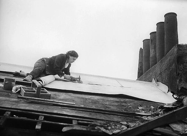 Woman Roofer tacking down the roofing felt 1941 women doing mens jobs during