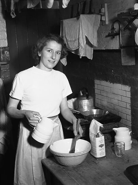Woman seen in the kitchen baking Circa February 1952