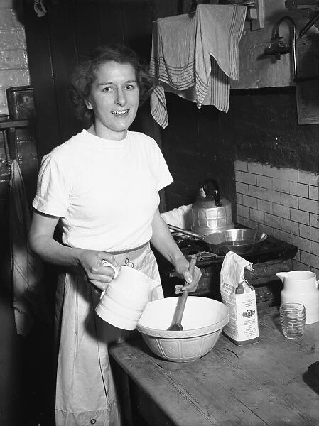 Woman seen in the kitchen baking Circa February 1952