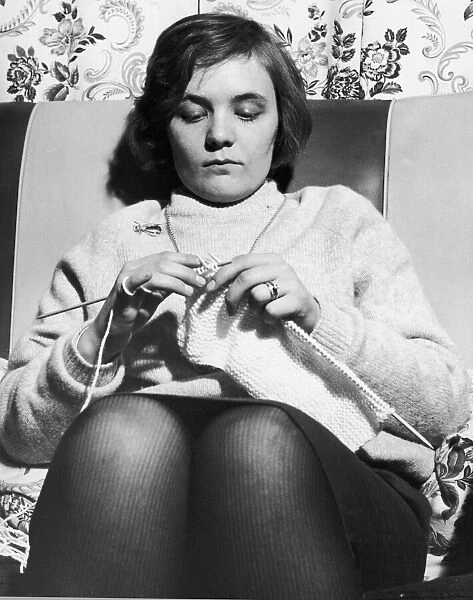 Woman seen here knitting a jumper circa 1965