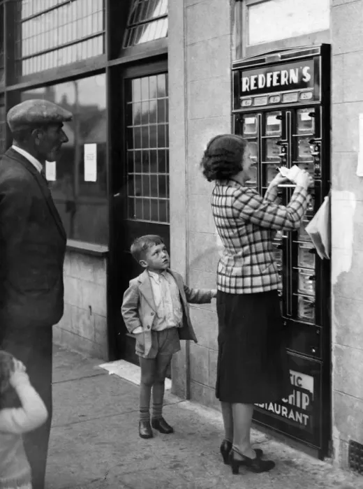 Framed Print : A woman seen here using the Automatic Fish and Chip dispenser at Redfern