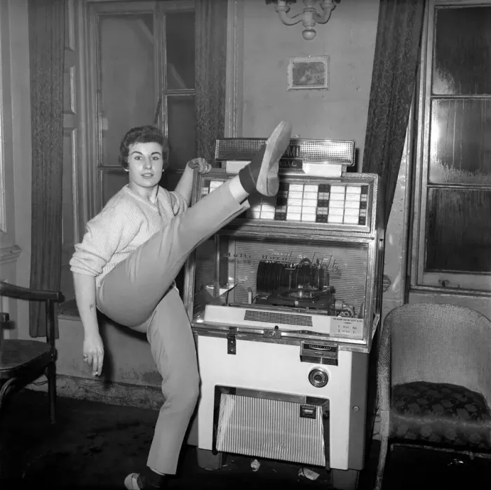 Framed Print : Woman selected tracks from juke box. 1960