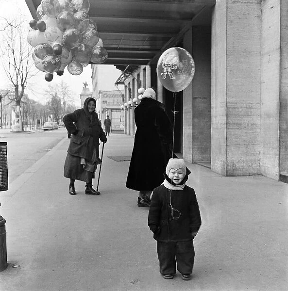 A woman selling balloons in Vienna. For hours the old lady of Vienna had tramped the cold
