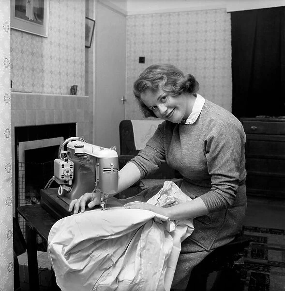 Woman at sewing machine: Mrs. John Theakeston seen here making a dress