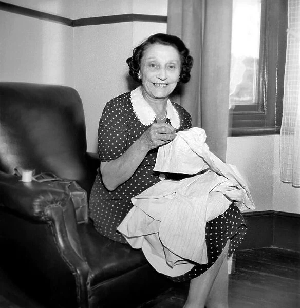 Woman with sewing machine. September 1953 D5640-001