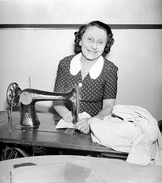 Woman with sewing machine. September 1953 D5640