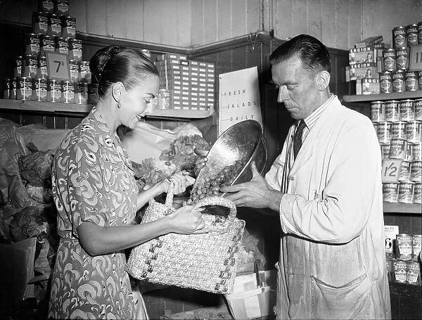 A woman shopping in a Greengrocers shop, 3rd July 1950