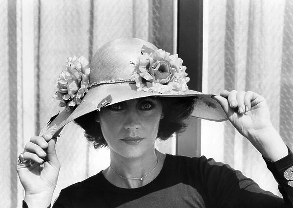 Woman showing off her flower covered hat May 1977 P007863