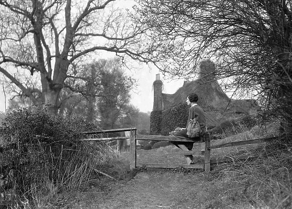 Woman sitting on gate, 21st March 1933