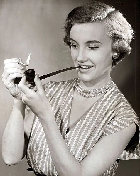 Woman smoking a pipe August 1954