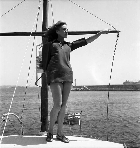 Woman standing on the front of her boat on holiday in South of France. July 1949 O20687