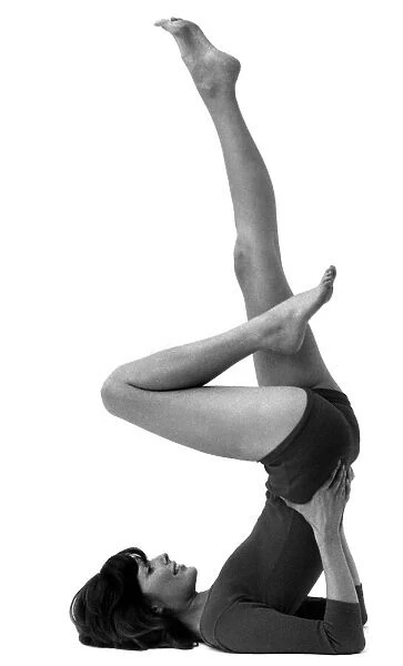 Woman stretching as she performs slimming exercises Circa 1975 P007921