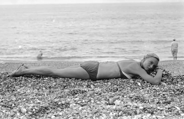 Framed Print : A woman sunbathing on the pebble beach at Brighton July 1958