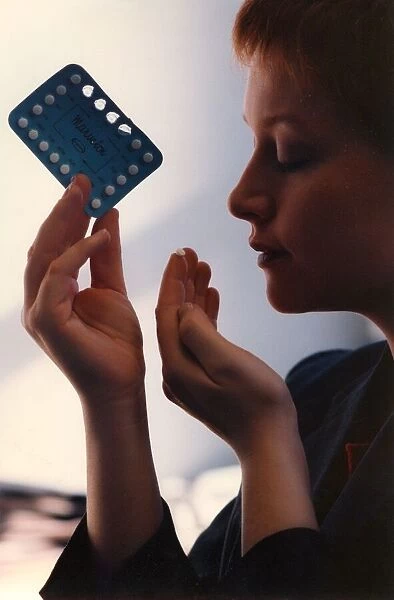 A woman taking a contraception pill