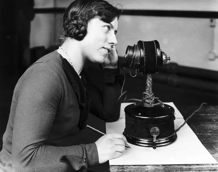 Framed Print : Woman using early telephone. Large candlestick phone Circa 1920 Framed Print : Woman using early telephone. Large candlestick phone Circa 1920