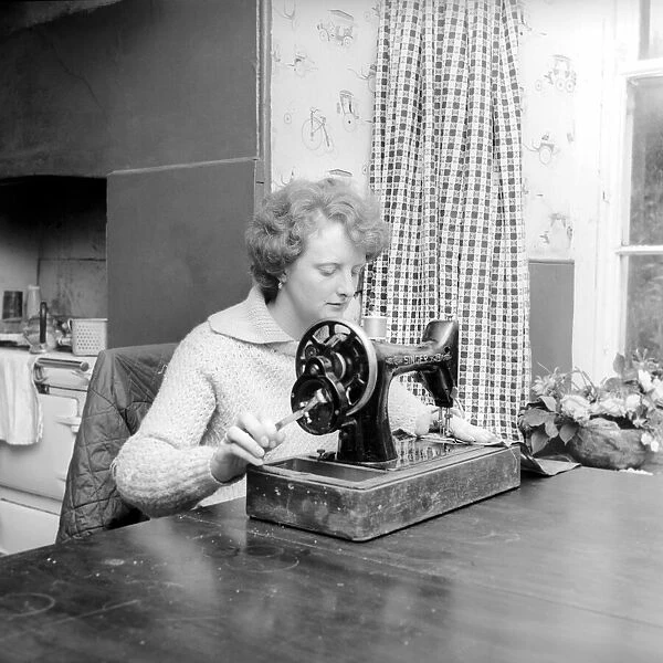 Woman using sewing machine. Circa 1964 A1137b-002