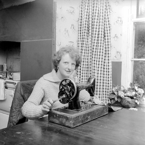 Woman using sewing machine. Circa 1964 A1137b-002