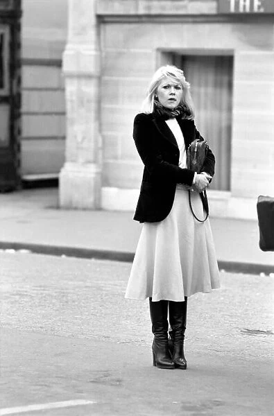 Woman walking through the streets of Paris, France. April 1975 75-2099-011