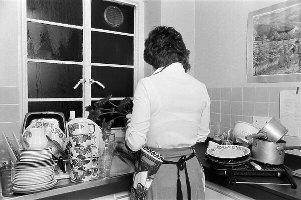 A woman washing up - one of the many daily chores of a housewife. 26th January 1979