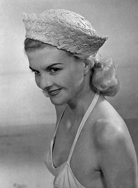 Woman wearing a bikini top and hat April 1953 P017644