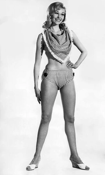Woman wearing a bikini with unusual neckscarf. June 1962 P011069
