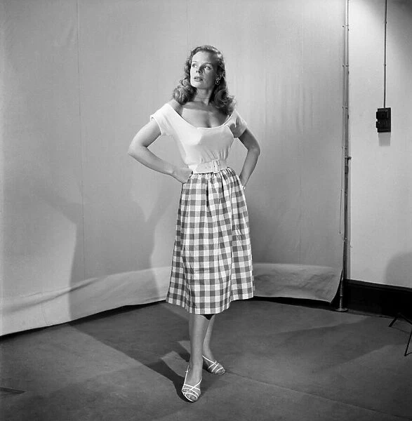 Woman wearing checked checked skirt and white short sleeved top