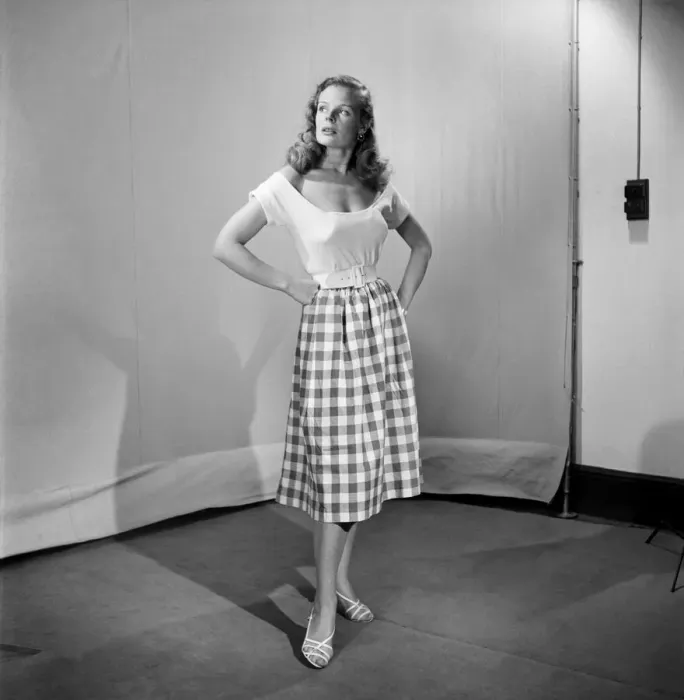 Framed Print : Woman wearing checked checked skirt and white short sleeved top