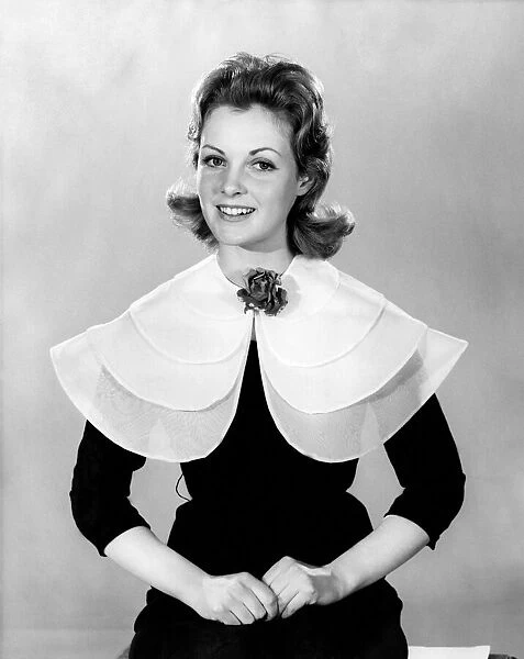 Woman wearing a dress with an unusually large collar March 1960 P009007